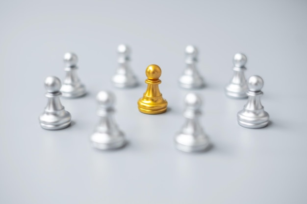 Golden chess pawn pieces or leader leader businessman with circle of silver men leadership business team and teamwork concept