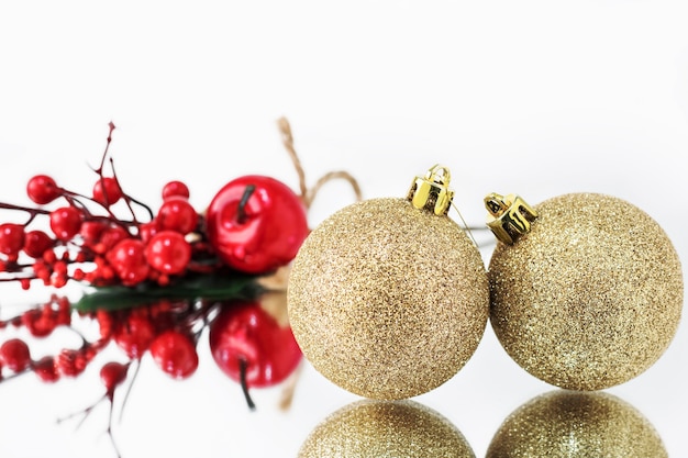 Golden Christmas balls are reflected in the mirror surface