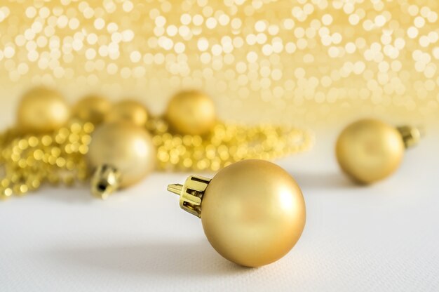 Golden Christmas balls background decoration lights snow winter copyspace.