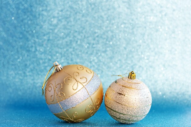 Golden christmas balls on table