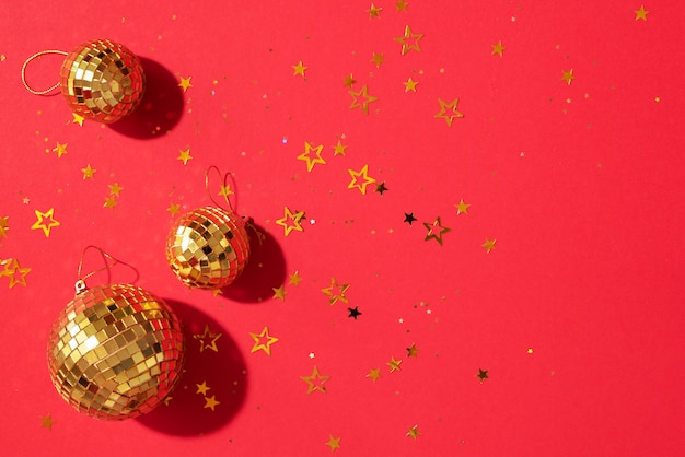 golden christmas balls with shiny stars on red background