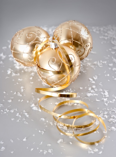 Golden christmas balls with snow decoration