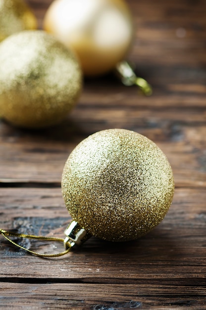 Golden christmas balls on the wooden table