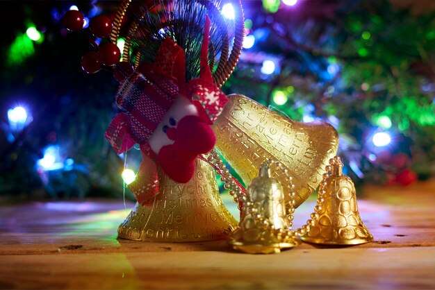 Golden christmas bells on wood merry christmas concept xmas decorations