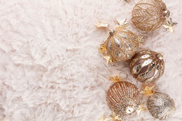 Golden christmas cozy balls with wool background.