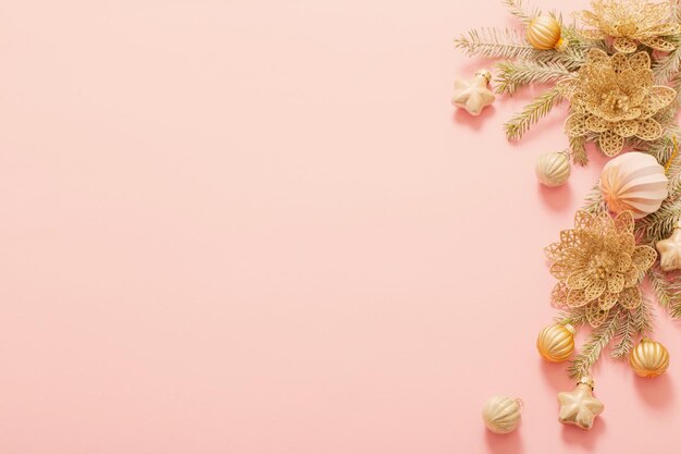 Golden christmas decorations on pink background