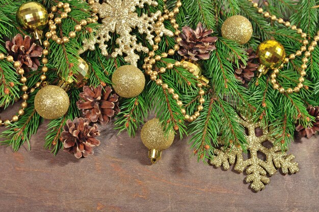 Golden Christmas decorations and spruce branch and cones