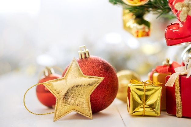 Golden Christmas Star and christmas decoration on table.