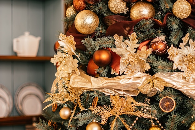 Golden Christmas tree look, decor in country style as holiday home decorations