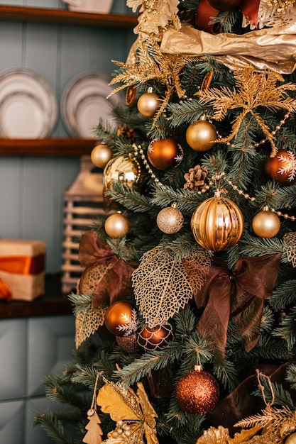 Golden Christmas tree look, decor in country style as holiday home decorations