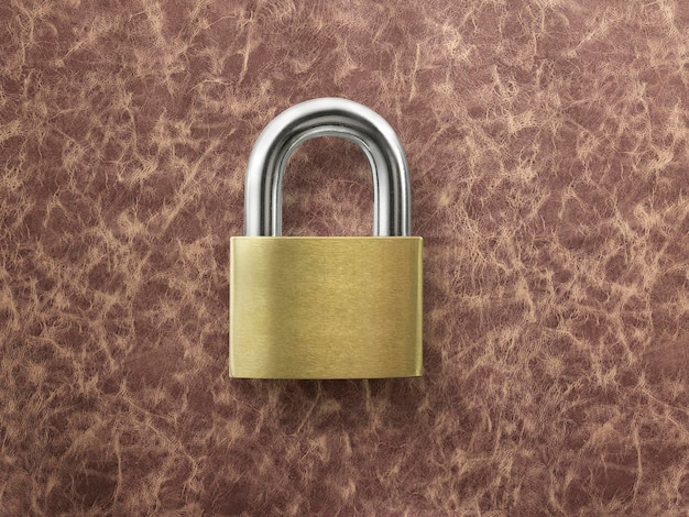 Golden closed lock on a brown leather background