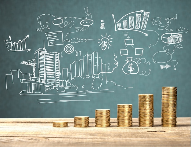 Photo golden coins stacks on wooden desk on diagrams background