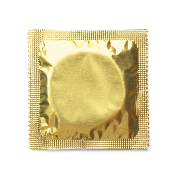 Golden condom package on white background top view Safe sex