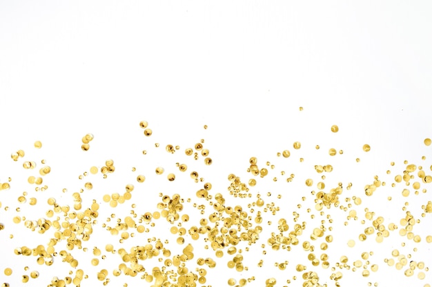 Photo golden confetti tinsel on white