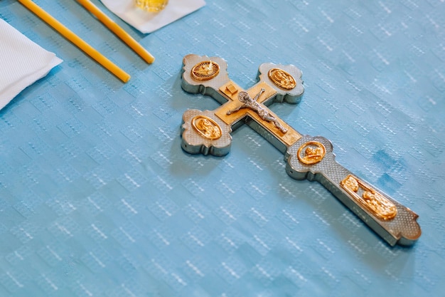 Golden cross on a background of delicate blue canvas in the holy church