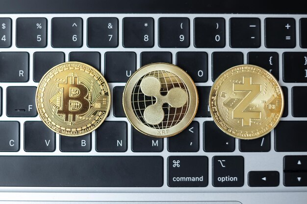 Photo golden cryptocurrency on keyboard laptop bitcoin zcach and ripple coins crypto is digital money within the blockchain network