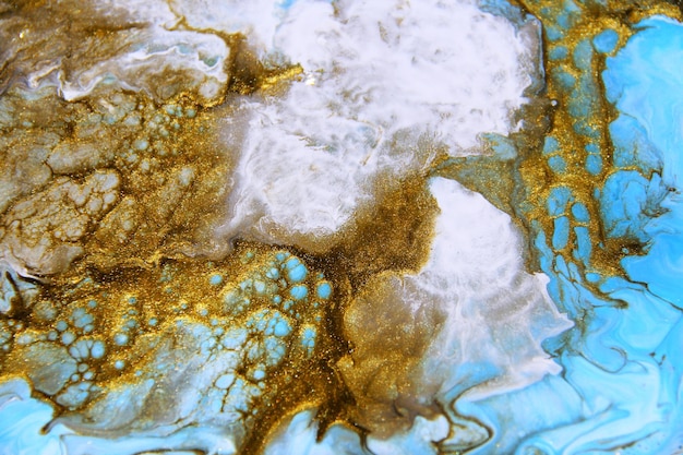 Golden and dark blue mixed acrylic paints Marble texture Liquid art