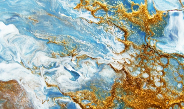 Golden and dark blue mixed acrylic paints Marble texture Liquid art