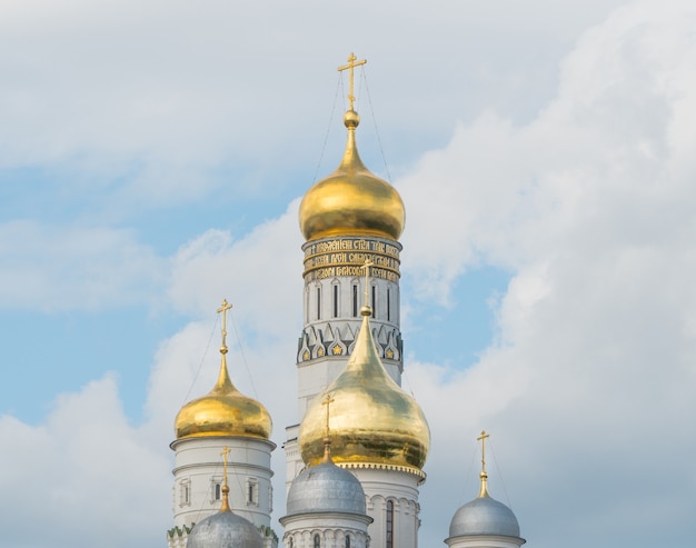 Golden domes of the church with crosses against the sky