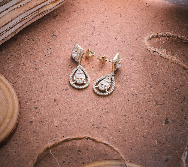 Golden earrings isolated with white crystals and diamonds Beautiful earrings on white background