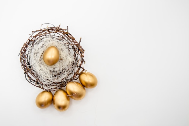 Golden Easter Eggs in a box with golden stars on white background 