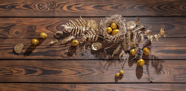 Golden easter eggs on dark wooden background