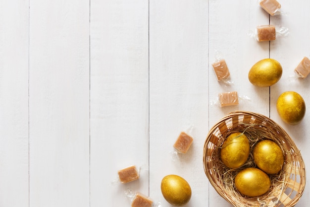 Golden easter eggs on wooden background