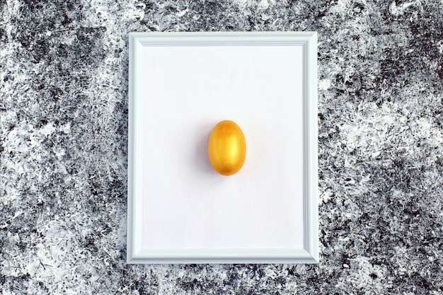 Golden egg on white frame