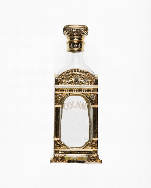 Photo golden empty cognac bottle isolated on white background