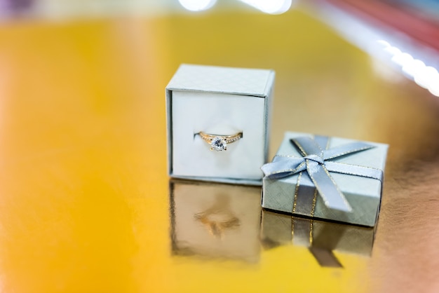 Golden engagement ring in silver gift box