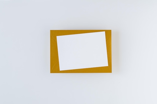 Golden envelope with card on white background