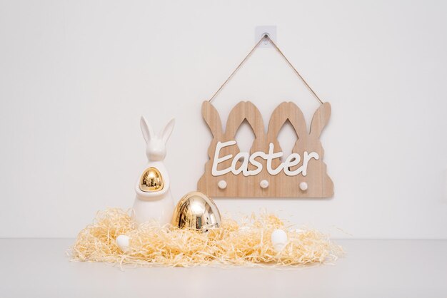 Golden ester bunny decor holiday concept thatch and eggs