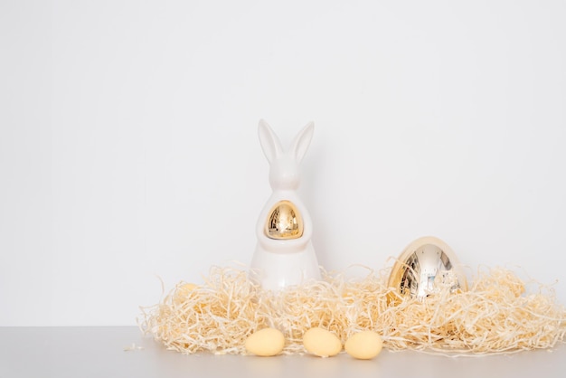 Golden ester bunny decor holiday concept thatch and eggs