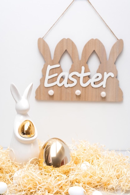 Golden ester bunny decor holiday concept thatch and eggs