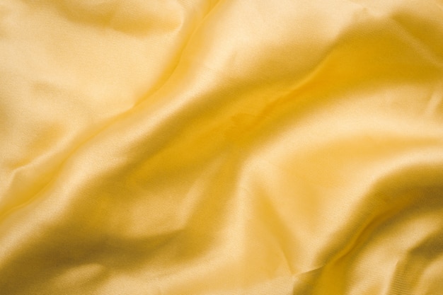 黄金の布のテクスチャの背景