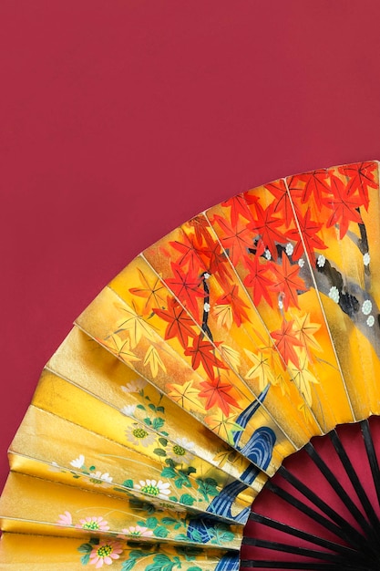 Golden fan on red background