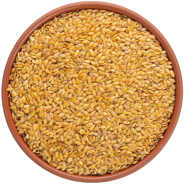 Golden flax in a brown ceramic bowl Isolated closeup photo of food