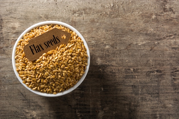 Golden flax seeds in white bowl