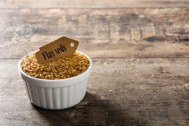 Golden flax seeds in white bowl