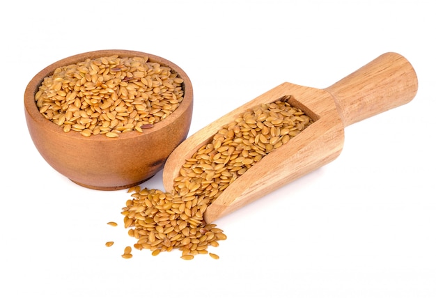 Golden flax seeds on a white