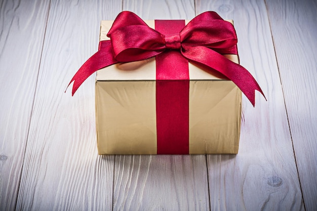 Golden gift box and red bow