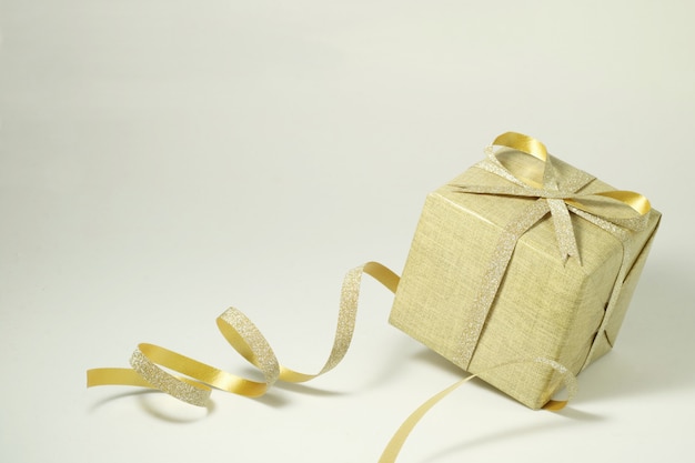 Golden gift box on white .                               