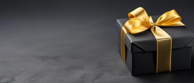 Golden gift box with bow on dark background