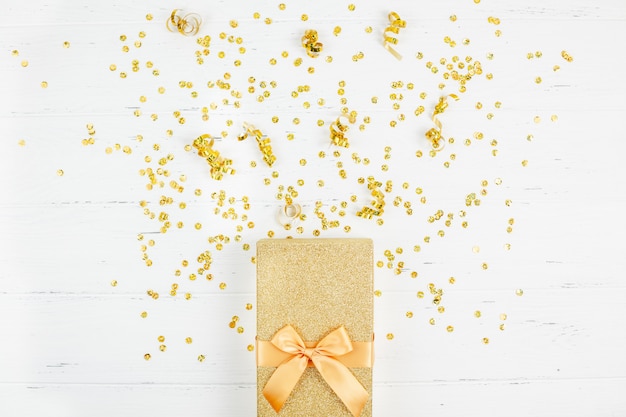 Golden gift box with confetti