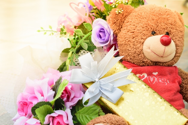 Golden gift boxes and bear for anniversary celebration.