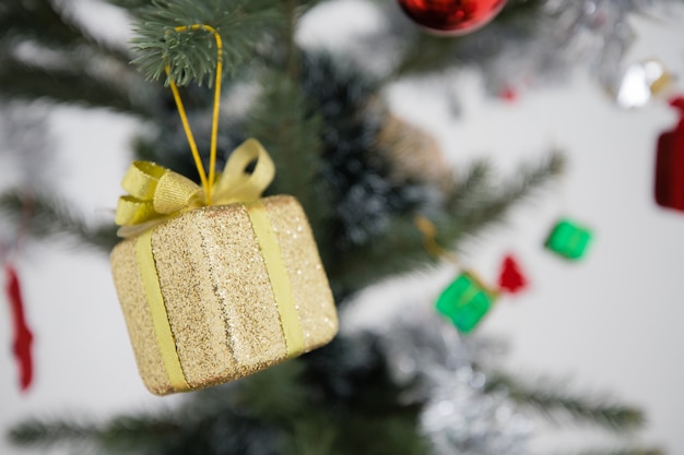 Golden gift boxes hung on Christmas trees.