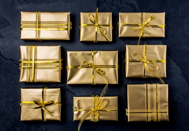 Golden gift boxes on slate 