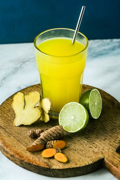 Golden ginger and turmeric drink with lime juice. Healthy anti-inflammatory drink of natural medicine and naturopathy