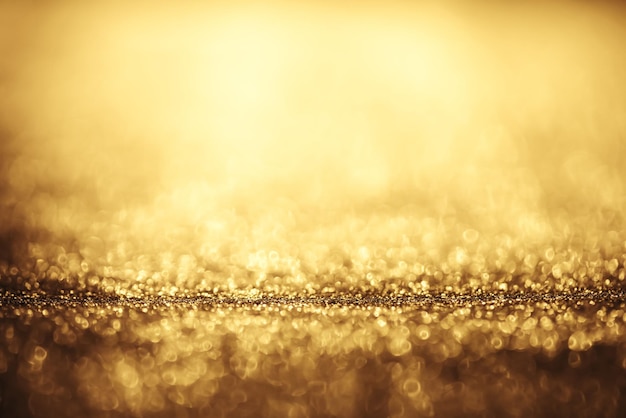 Golden glitter bokeh lighting texture Blurred abstract background for birthday anniversary wedding new year eve or Christmas