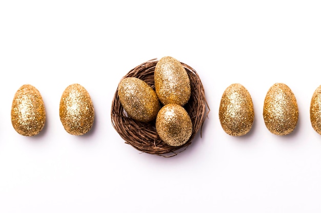 Golden glitter eggs in a nest Easter background Finance concept